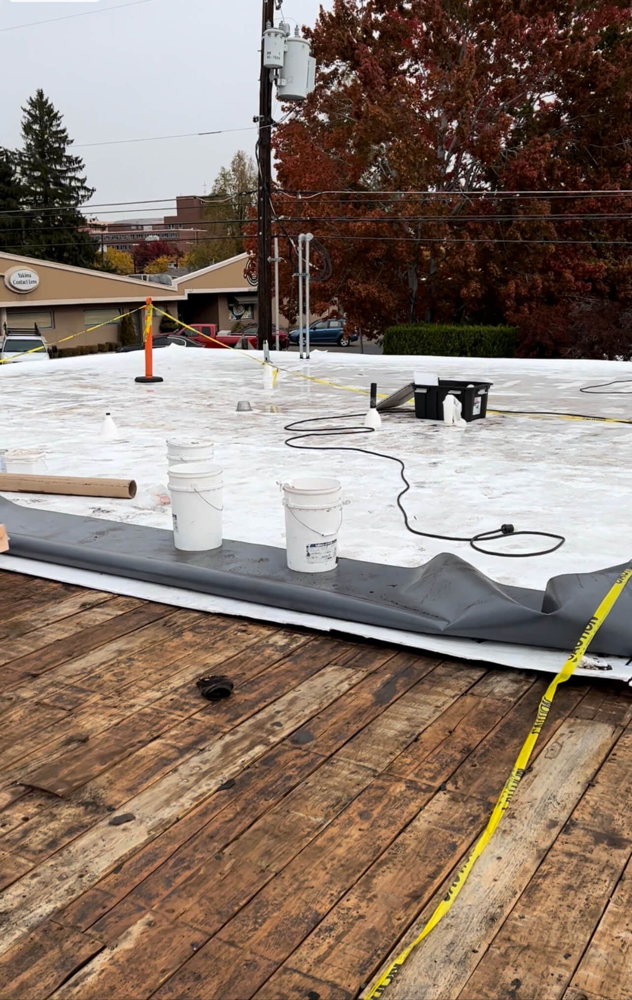 Workers preparing the roof deck at Labcorp Yakima after removing the old built-up roofing system.