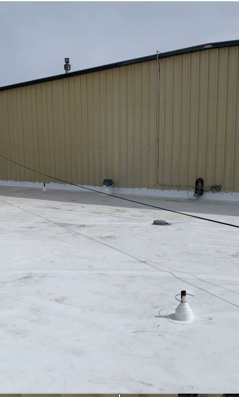 View of the Syntec US roof during tear-off, showing a clean surface and preparation for the TPO membrane installation.