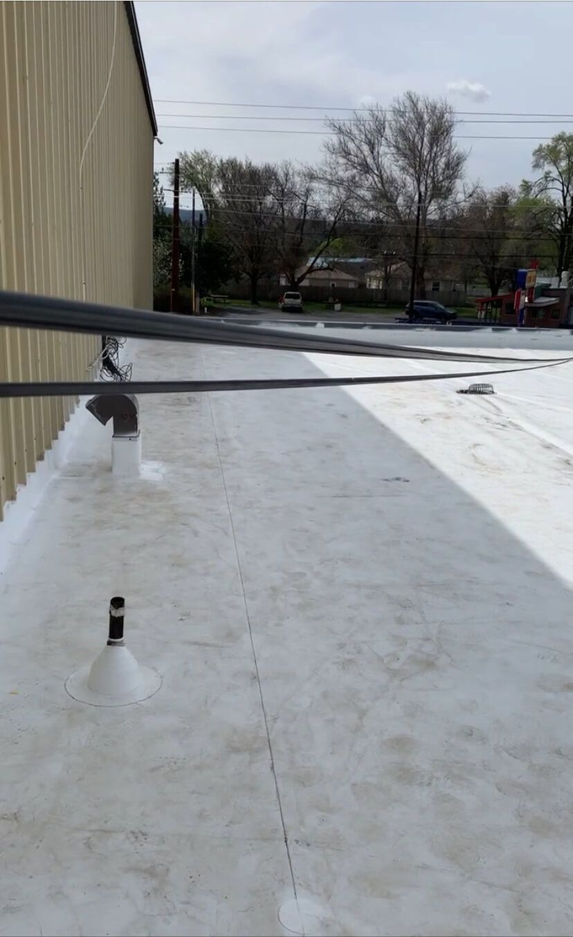 Close-up of a roof drain installation on the white TPO membrane at Syntec US in Yakima.