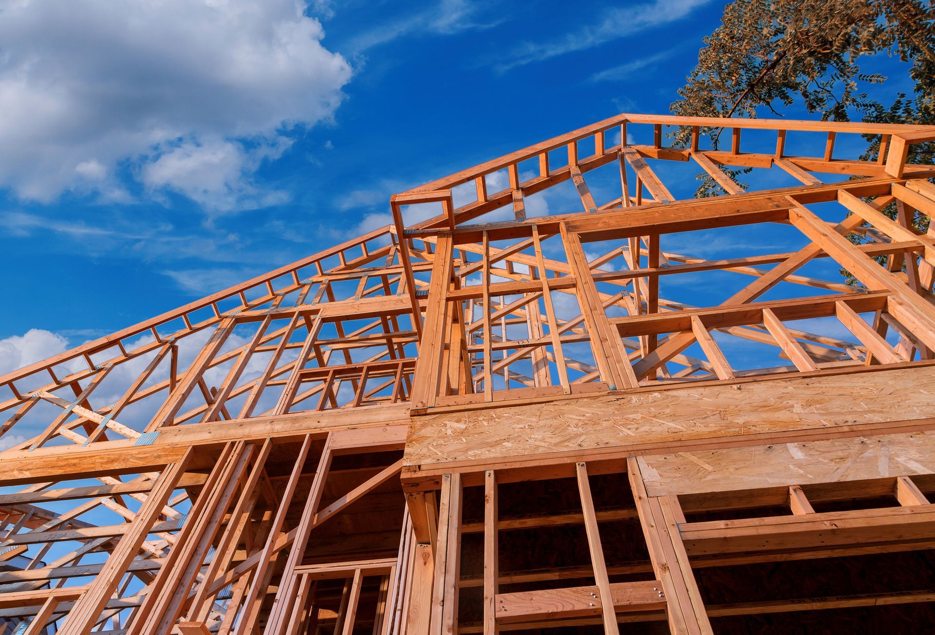 A house is being built with a blue sky in the background