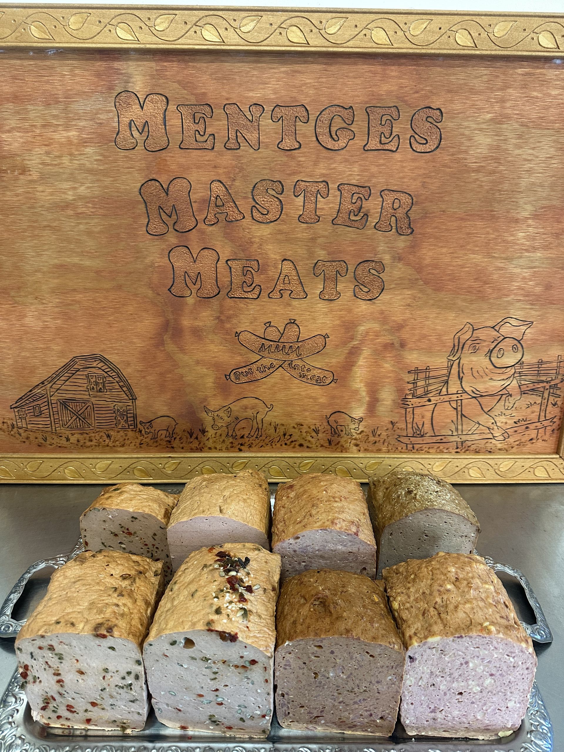 A Loaf of Meatloaf with Green Beans and Ketchup on A Cutting Board — Mentges Master Meats Traditional Continental Smallgoods In Taree, NSW