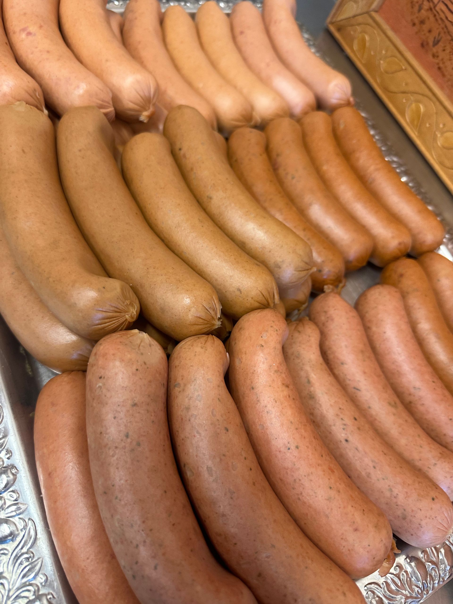 A Ham Is Being Sliced on A Wooden Cutting Board — Mentges Master Meats Traditional Continental Smallgoods In Taree, NSW