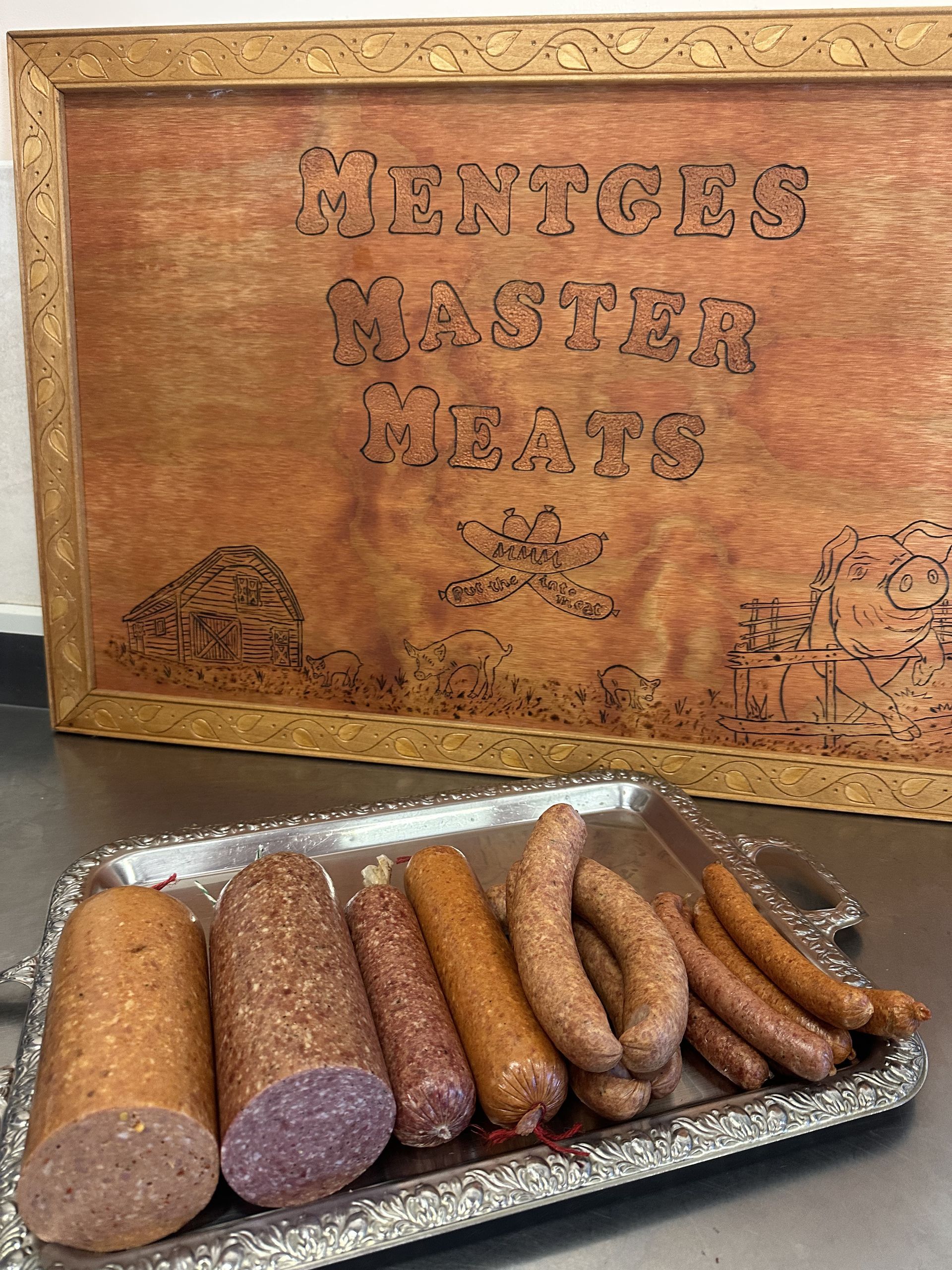 A Variety of Meats and Sausages Are Sitting on A Wooden Table — Mentges Master Meats Traditional Continental Smallgoods In Taree, NSW
