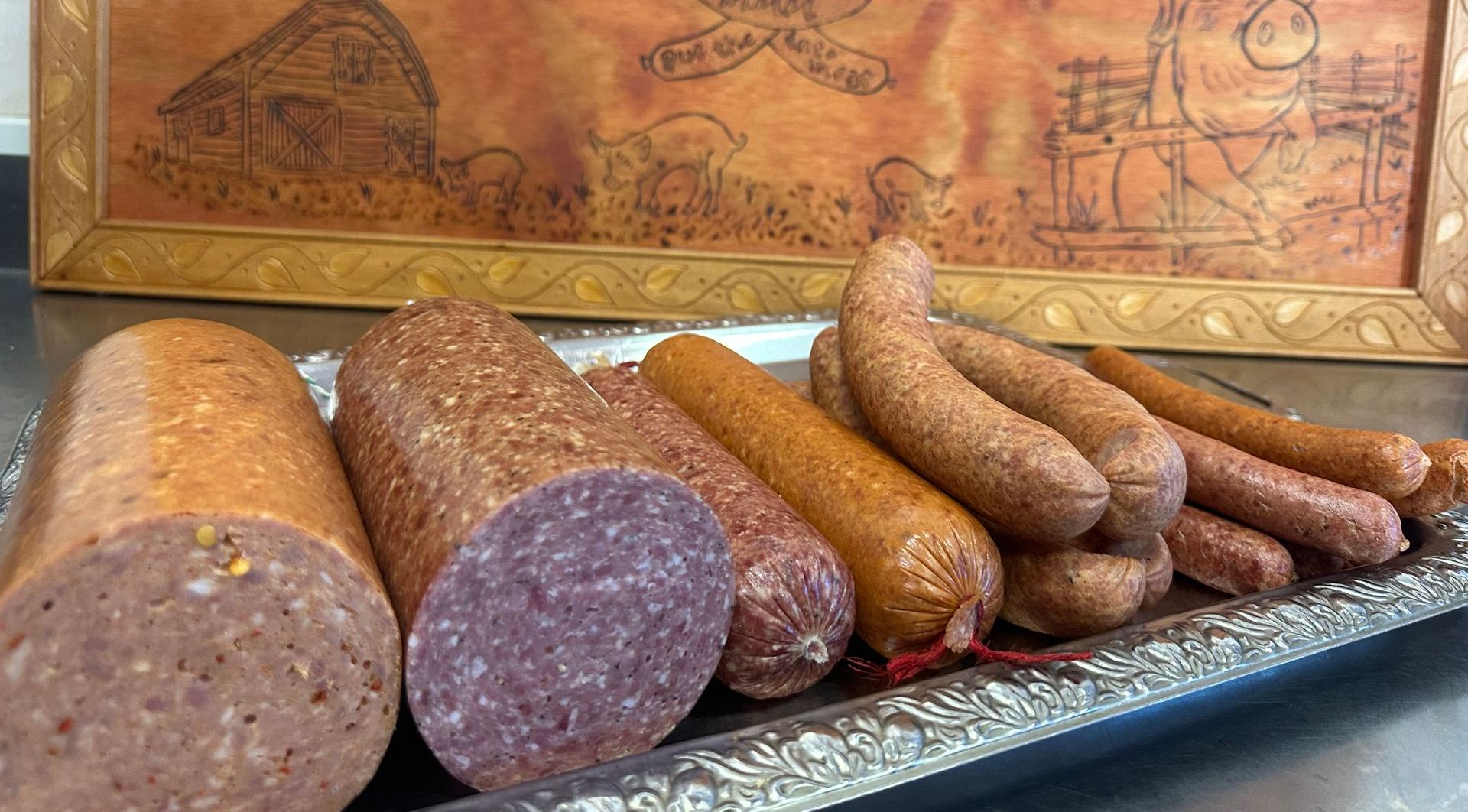 A Wooden Box Filled With Bread is Sitting on a Table Next to a Tray of Bread — Mentges Master Meats Traditional Continental Smallgoods In Taree, NSW