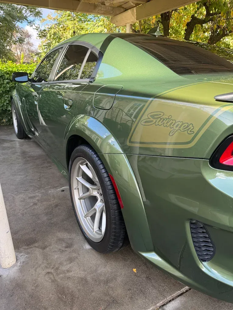 Green Dodge Charger with aftermarket wheels, 