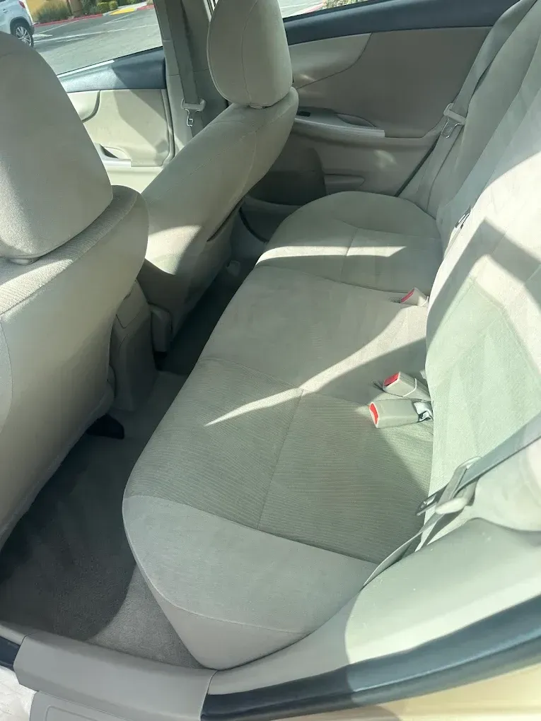 Beige Toyota Corolla backseat interior.