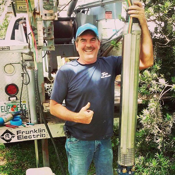 Man Holding The Drilling Machine — Tampa, FL — Tampa Well Drilling