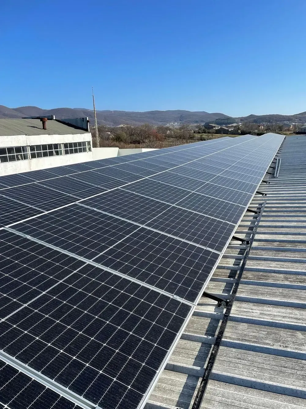 Solar panels installed on a rooftop on a sunny day.