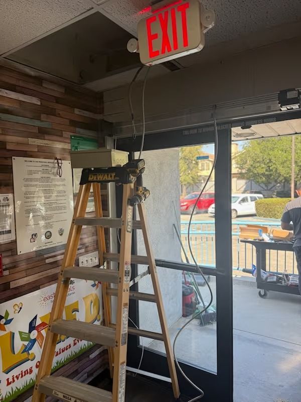 A ladder is set up near a door with an 