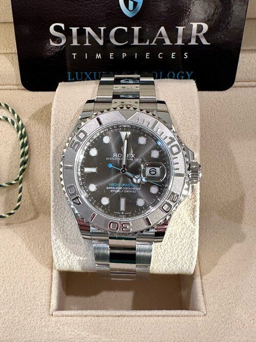 A sinclair timepieces watch is sitting on a display case