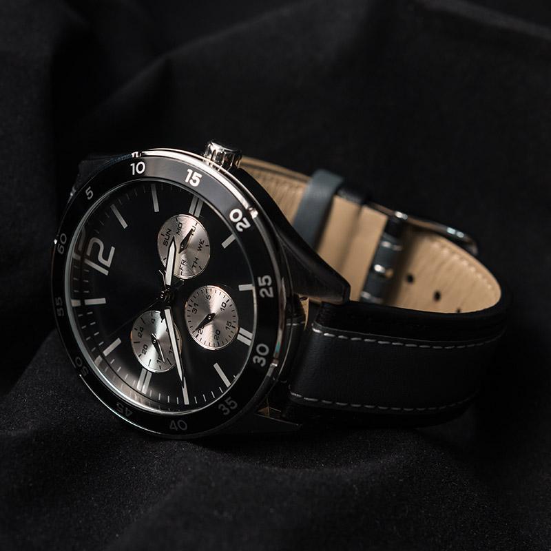 A black watch with the number 12 on the face