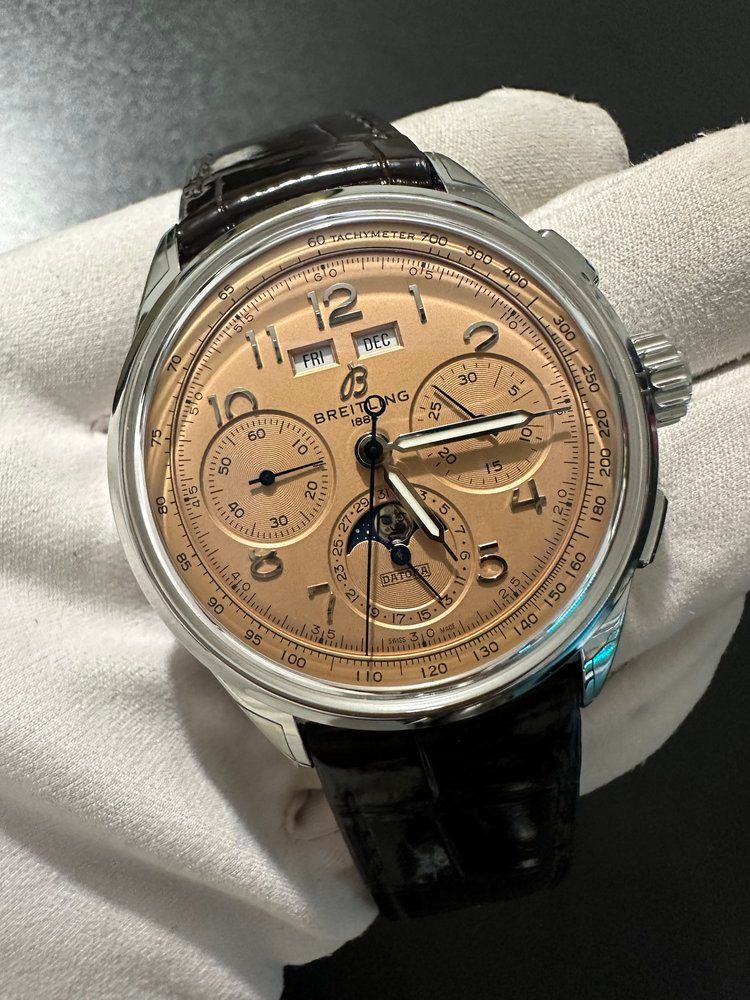 A person is holding a watch in their hand.