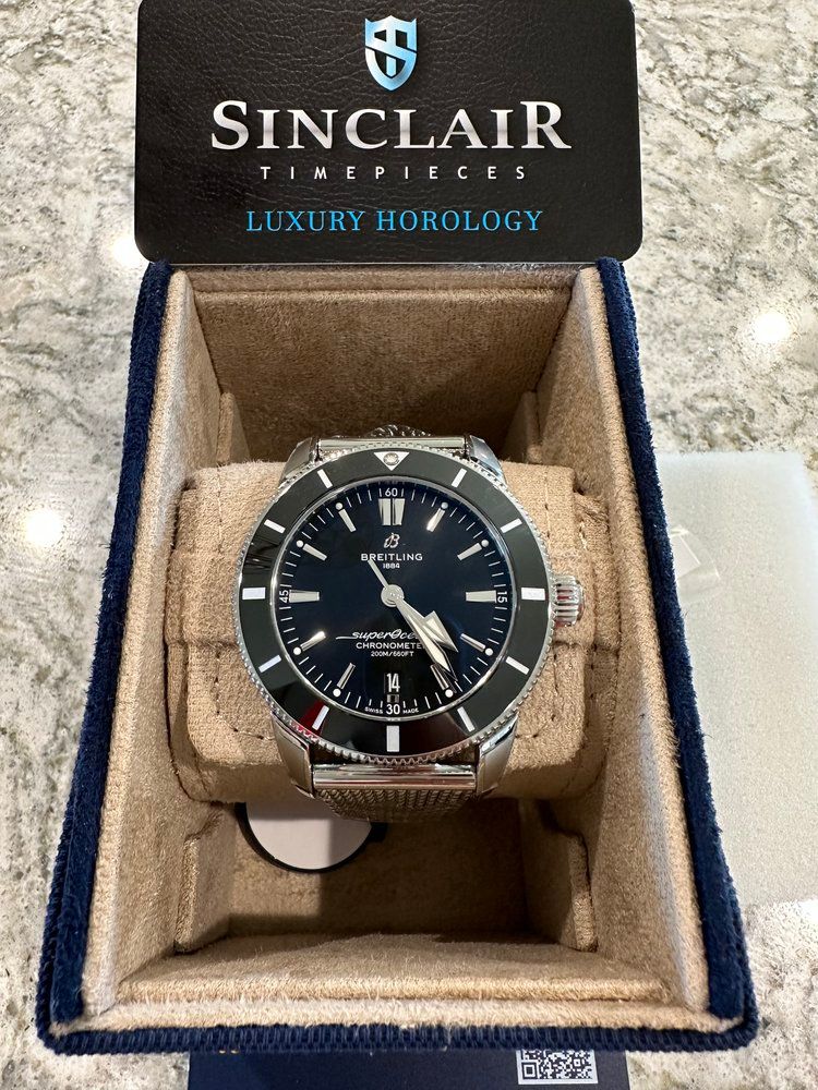 A sinclair watch is sitting in a box on a table.