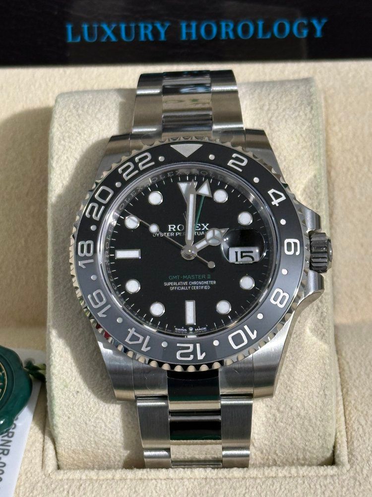 A rolex watch is in a box that says luxury horology