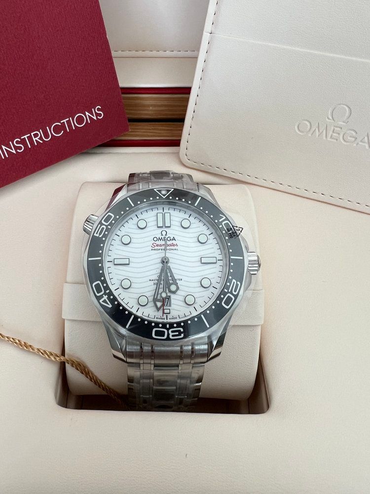 An omega watch is in a box with instructions