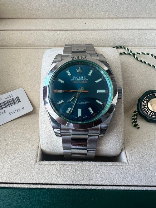 A silver rolex watch with a blue face