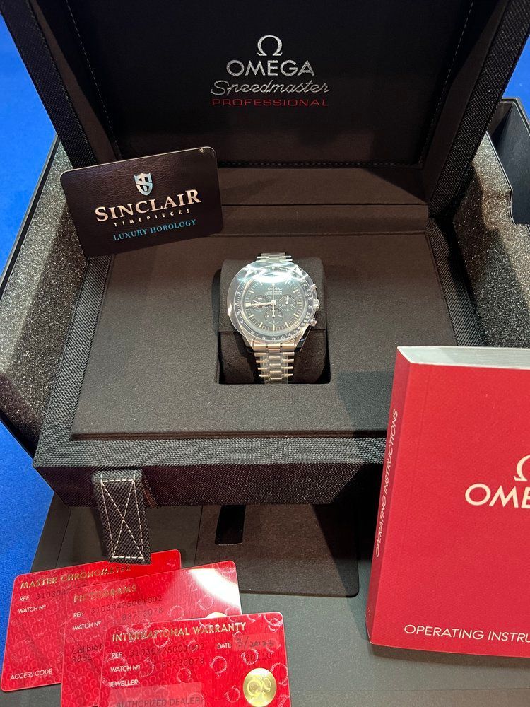 A omega watch is in a box with a certificate