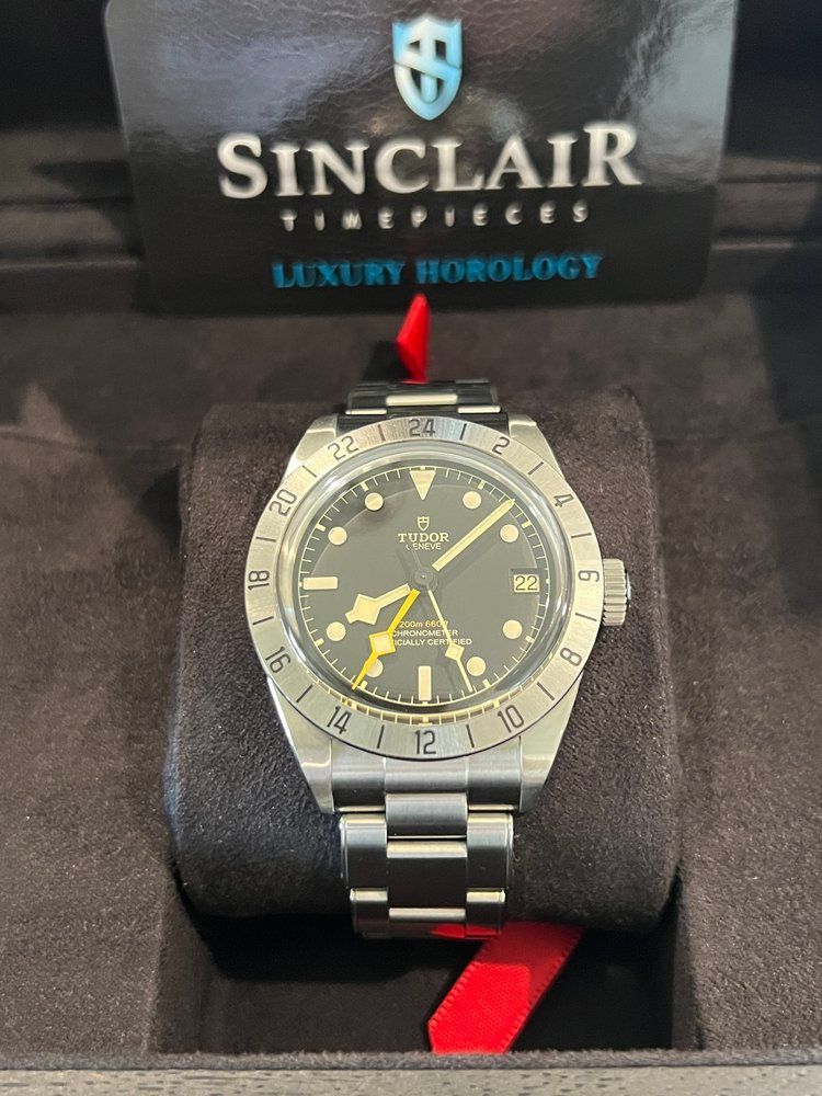 A tudor watch is sitting inside of a black box.