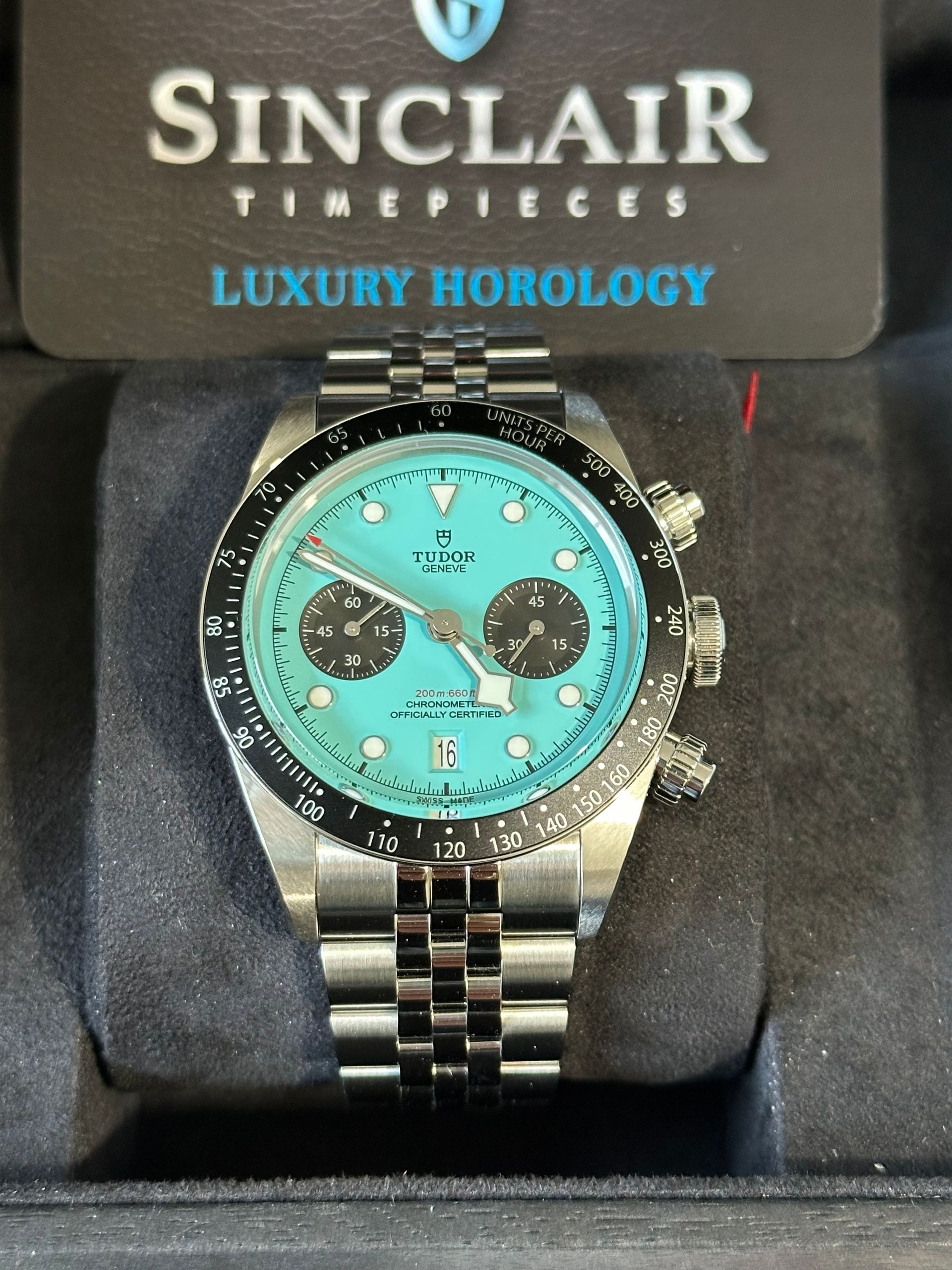 A rolex watch is sitting on top of a white cushion.