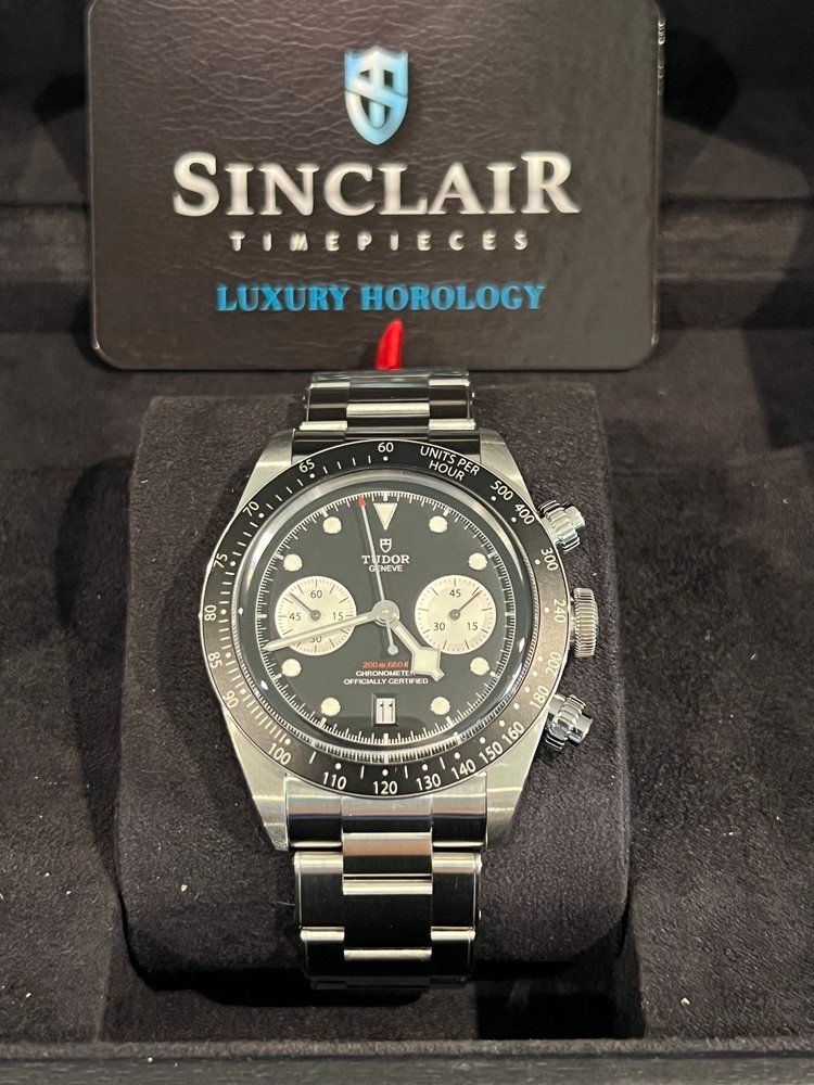 A tudor watch with a blue face and black band