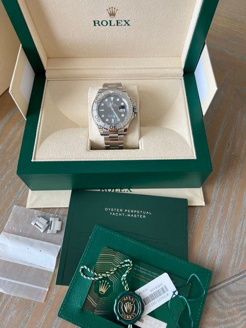 A rolex watch is in a box on a table
