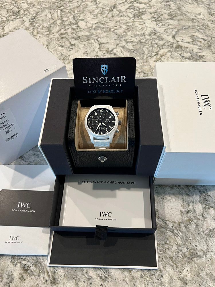 A sinclair watch is sitting in a box on a counter.