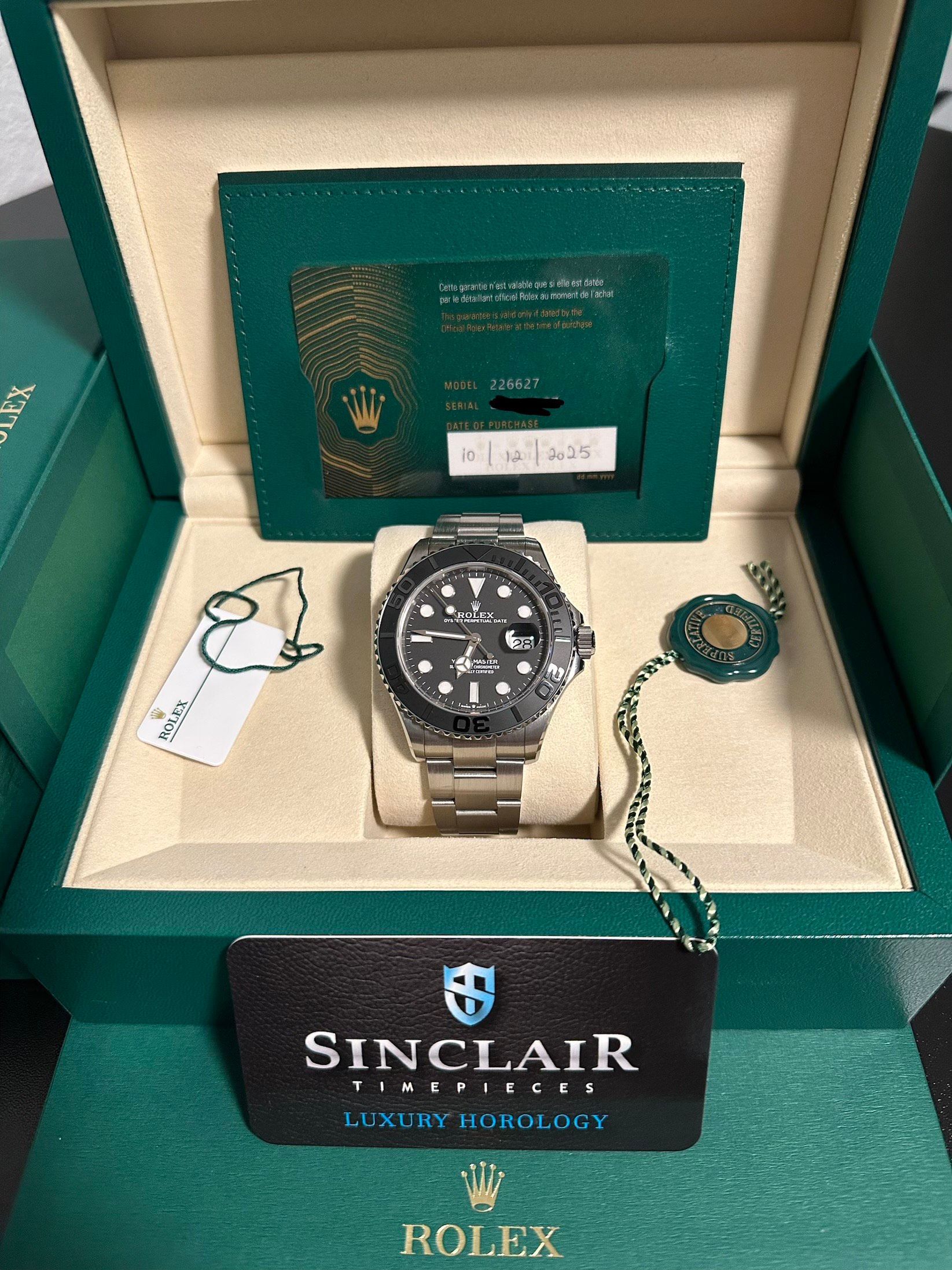 A rolex watch is sitting on top of a white cushion.