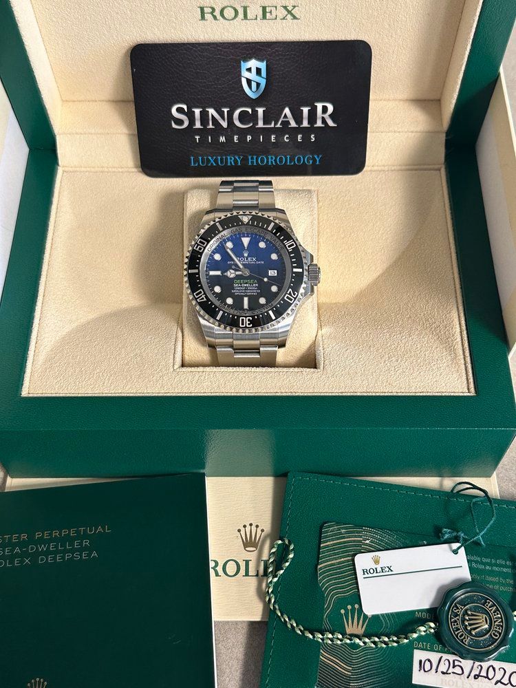 A rolex watch in a box with a sinclair card