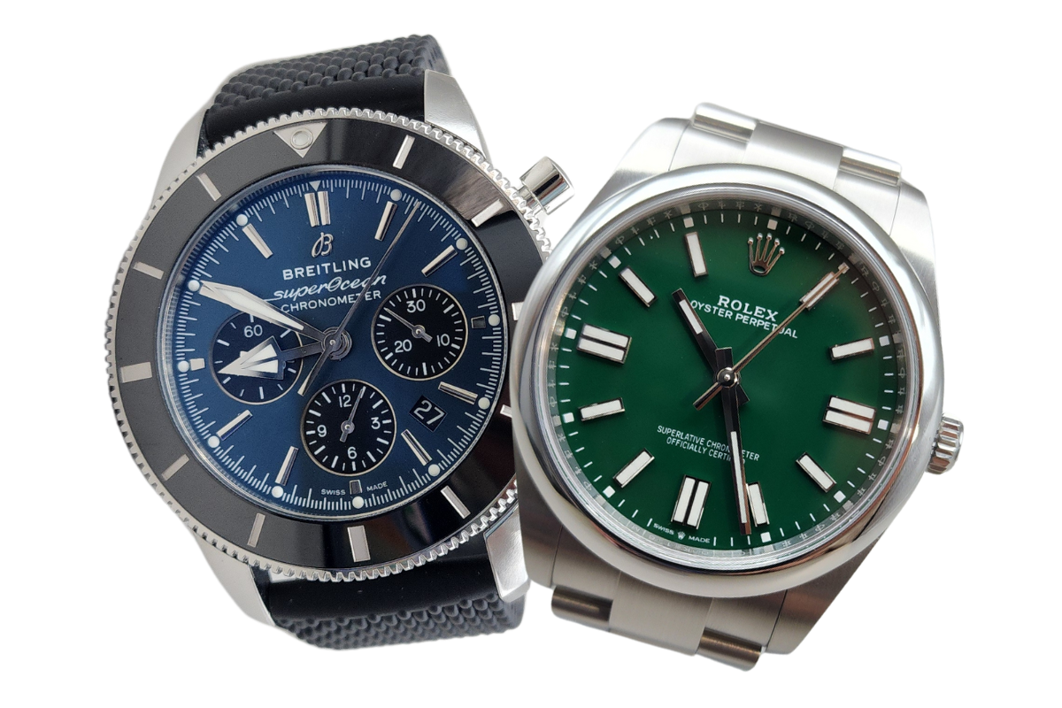 Two watches are sitting next to each other on a white background.