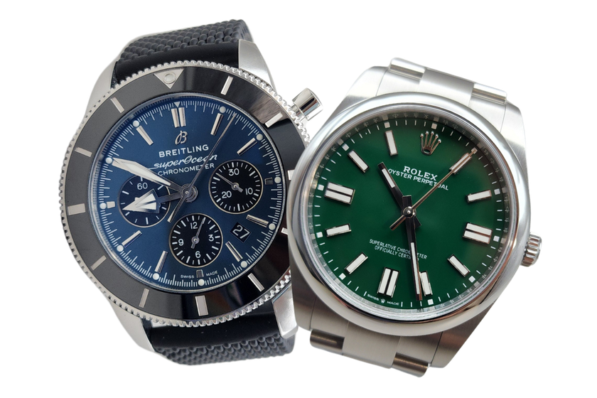 Two watches are sitting next to each other on a white background.