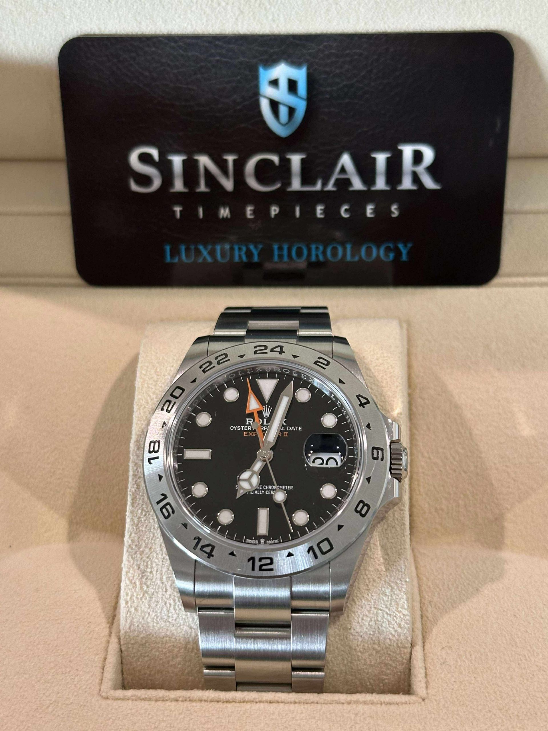 A sinclair watch is displayed in a black case