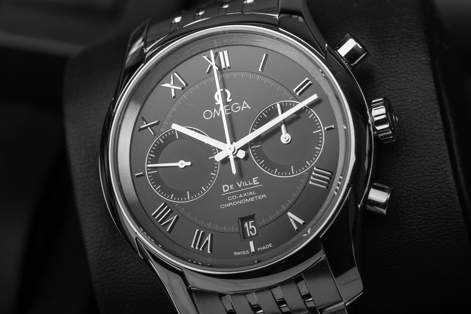 A black and white photo of an omega watch