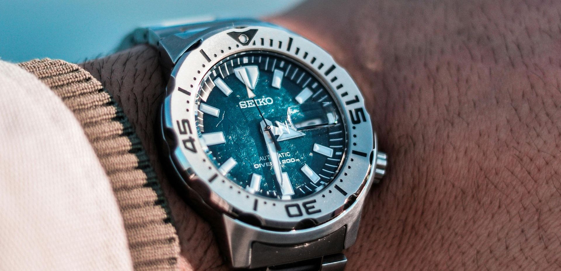 A close up of a person wearing a watch on their wrist.