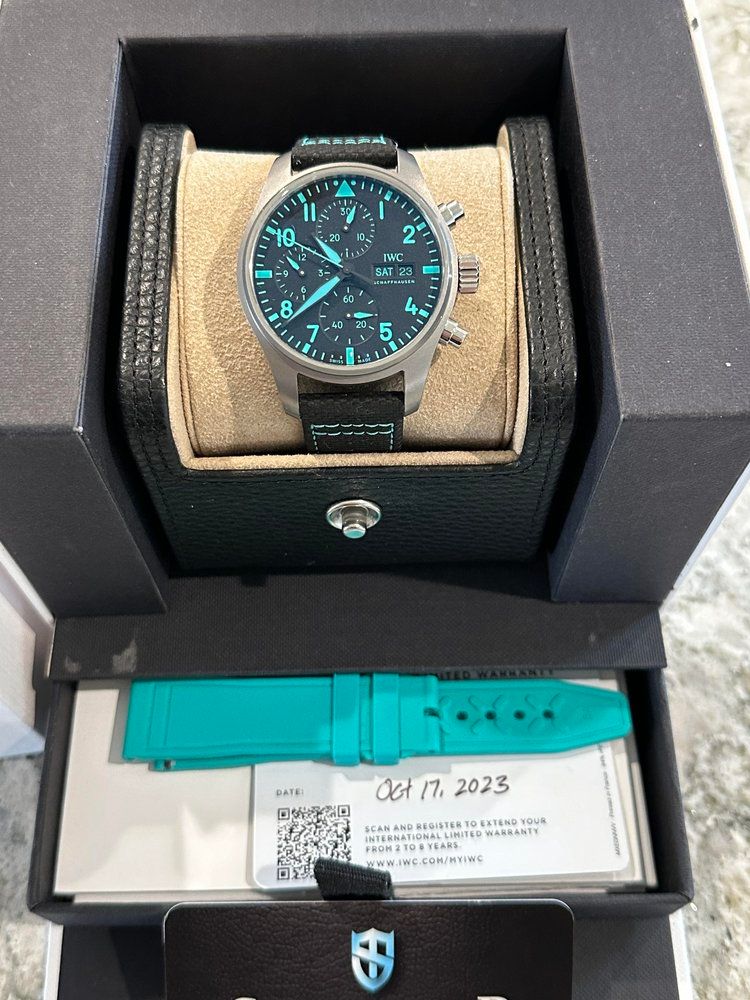 A watch with a blue band is in a box