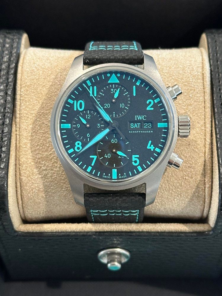 A silver watch with a black band and a blue face