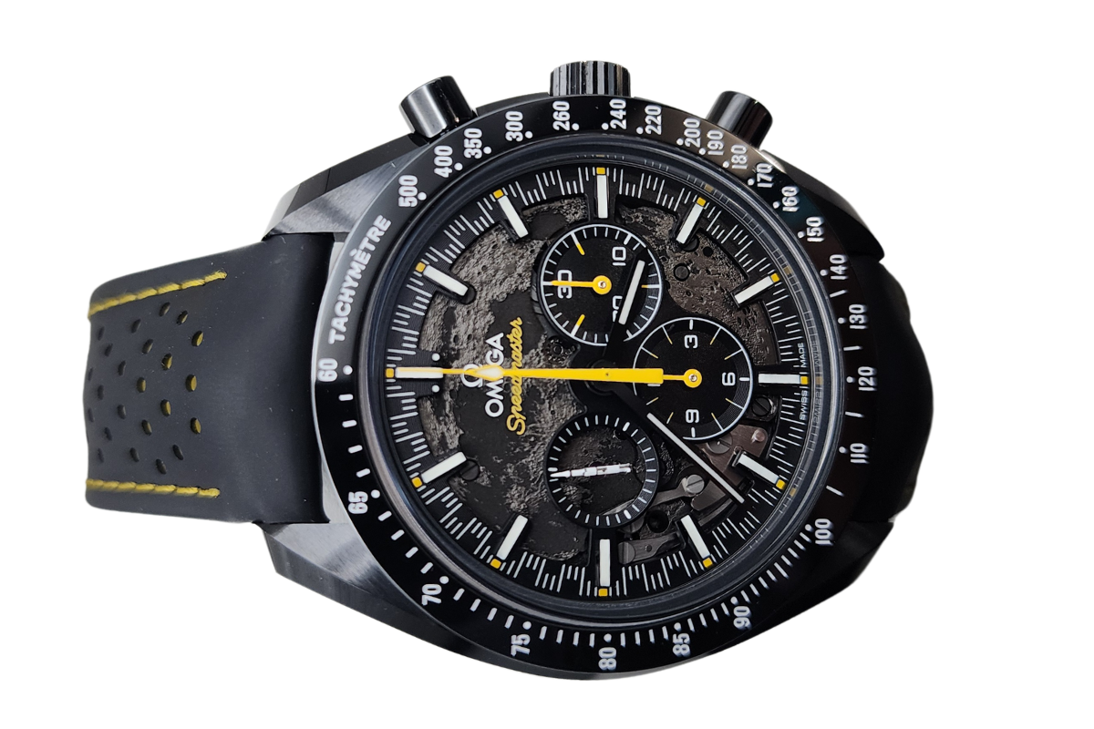 A close up of a black and yellow watch on a white background.