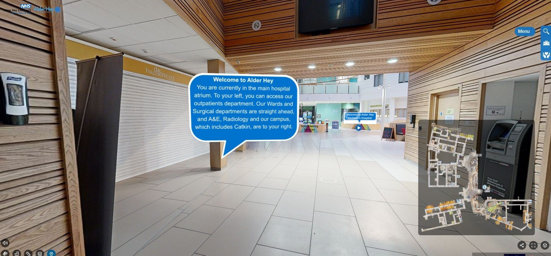 An aerial view of a large building with a play button in the middle.