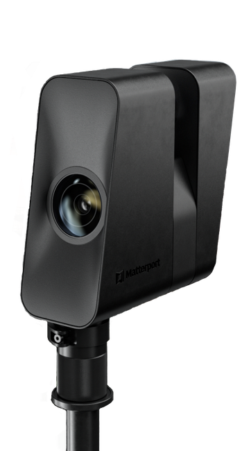 A black camera is sitting on top of a metal pole.