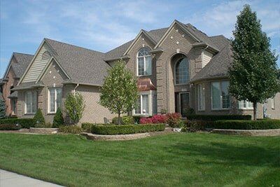 Large House Brown House With Trees — Landscaping in Shelby Township, MI