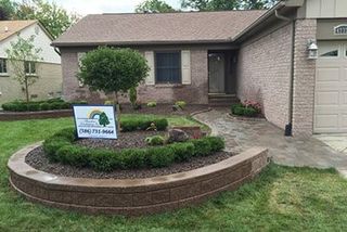 House With Rainbow Landscaping Inc Logo Outside — Landscaping in Shelby Township, MI