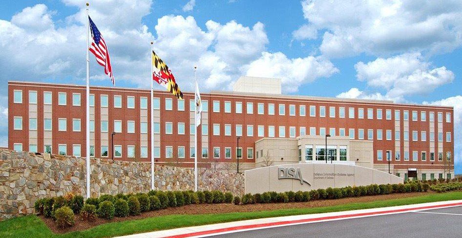 A large brick building with flags flying in front of it