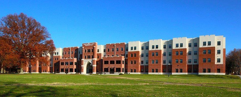 A large brick building with a tree in front of it