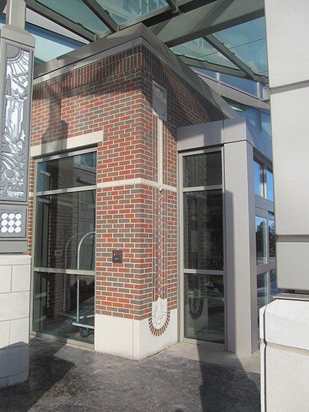 A brick building with a large glass roof