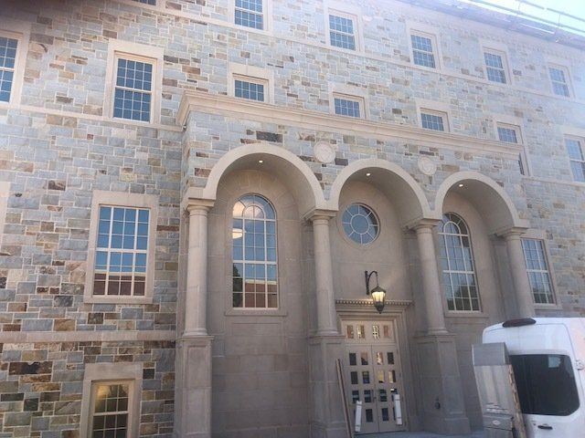 A large stone building with arched windows and columns