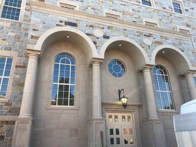 A stone building with arched windows and columns