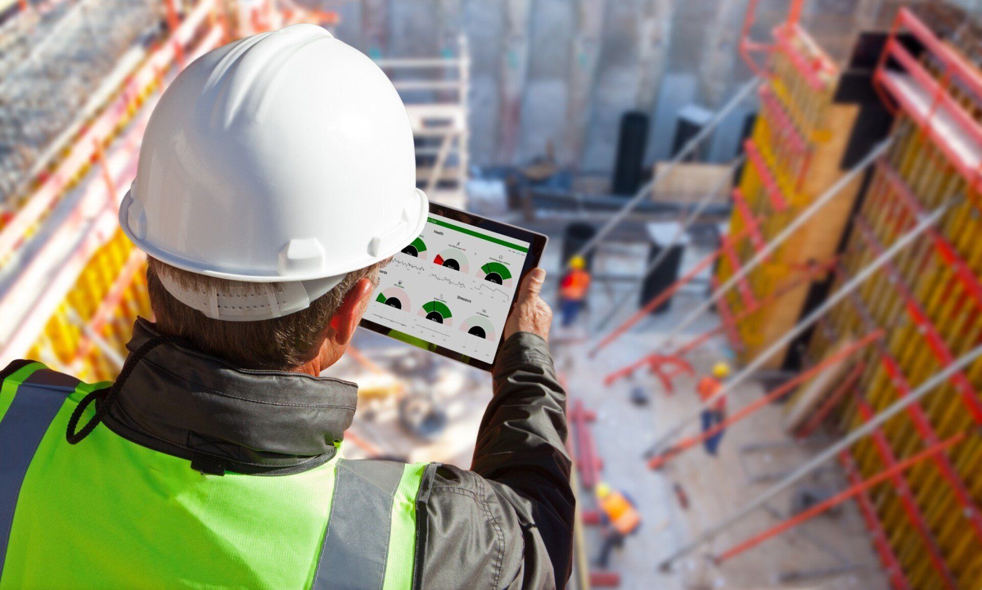Construction worker using SafeGuard on tablet to monitor workers bio signs.
