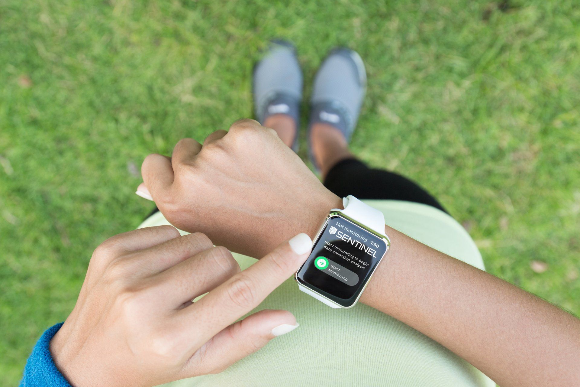 Woman in sports wear wearing a smart watch showing an app
