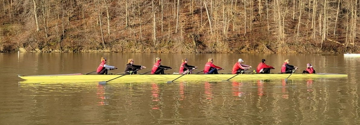 UI Womans rowing team on a lake rowing