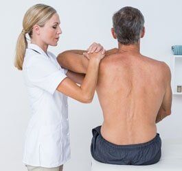 Doctor Examining Patient — Chiropractic Care in Brevard Country, FA