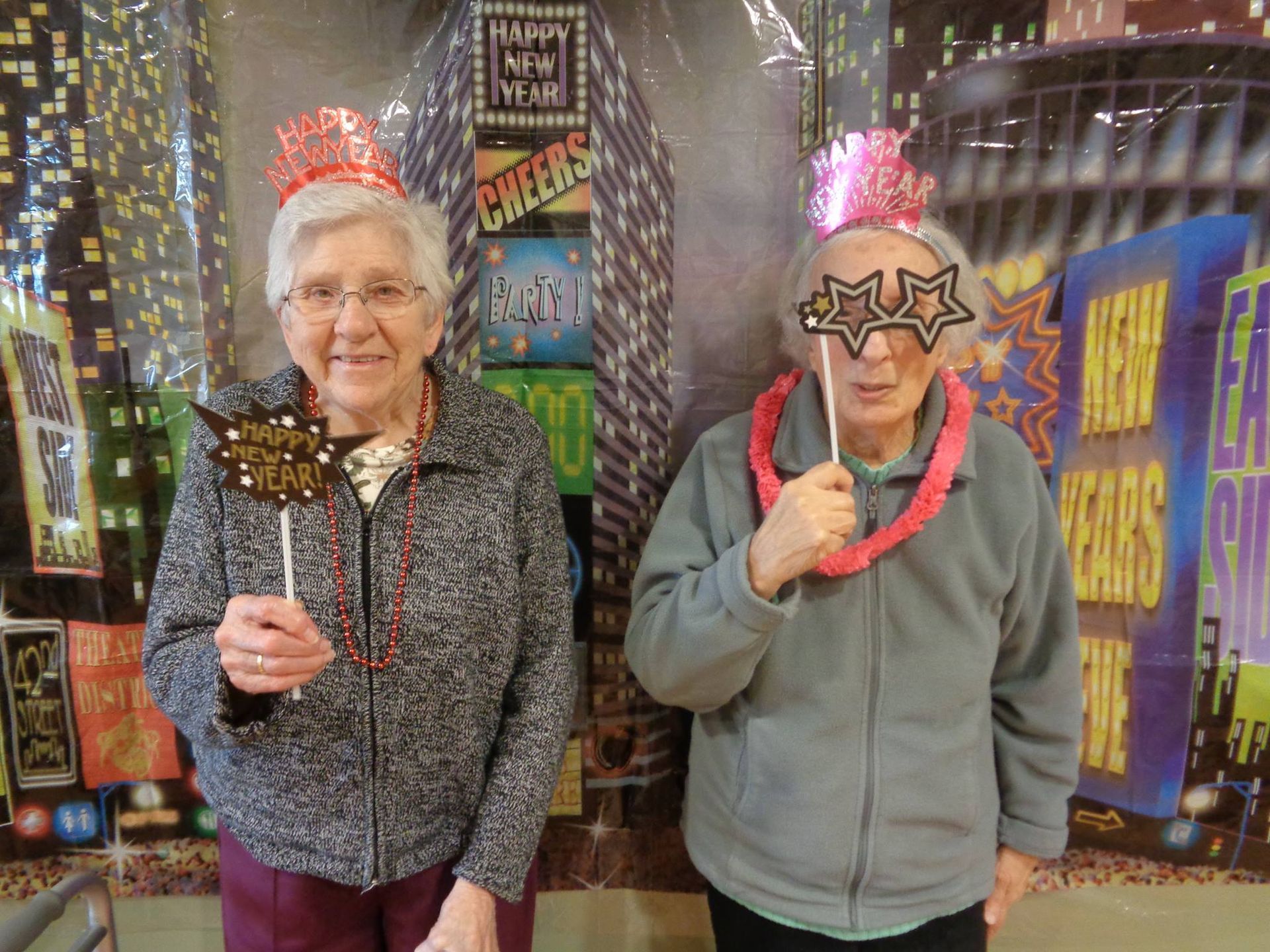 A group of elderly people are sitting at tables in a dining room.